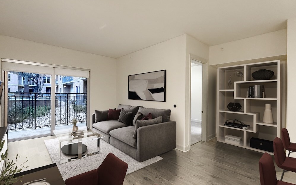 living room with large windows and a couch with a coffee table