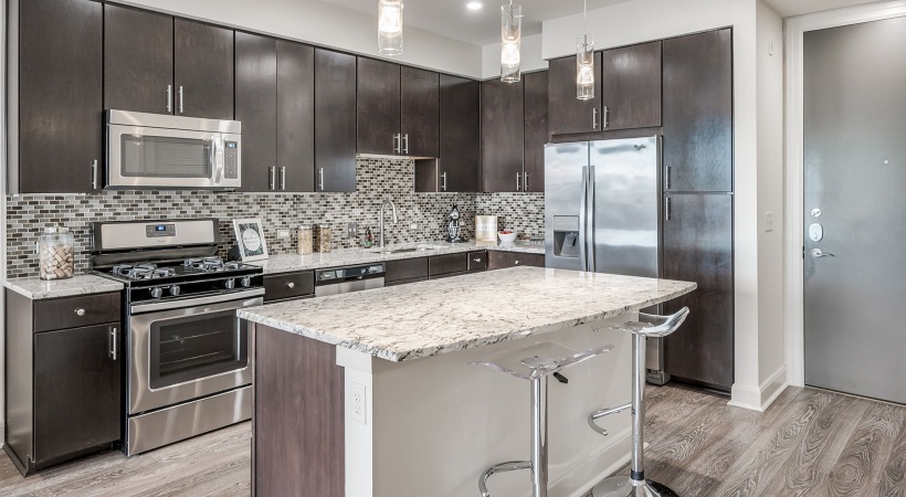 Well-lit kitchen with ample counter space and wood-style flooring