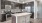 Well-lit kitchen with ample counter space and wood-style flooring