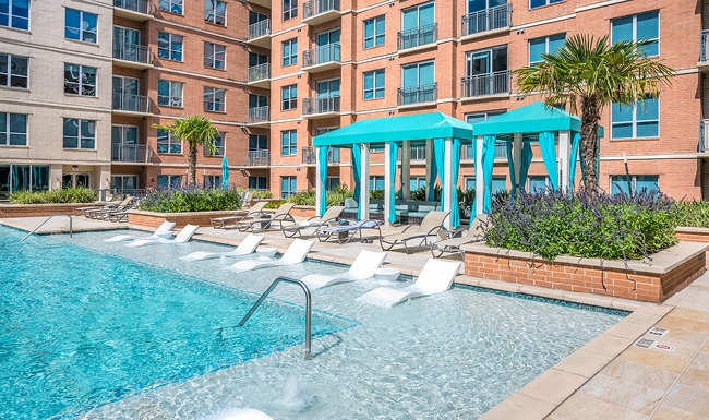 Resort-style swimming pool with lounge seating